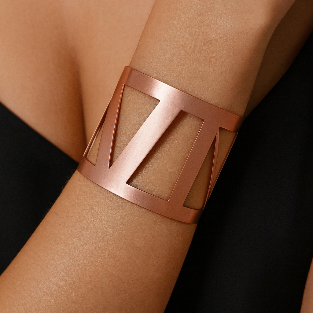Rigid rose gold-tone cuff bracelet.